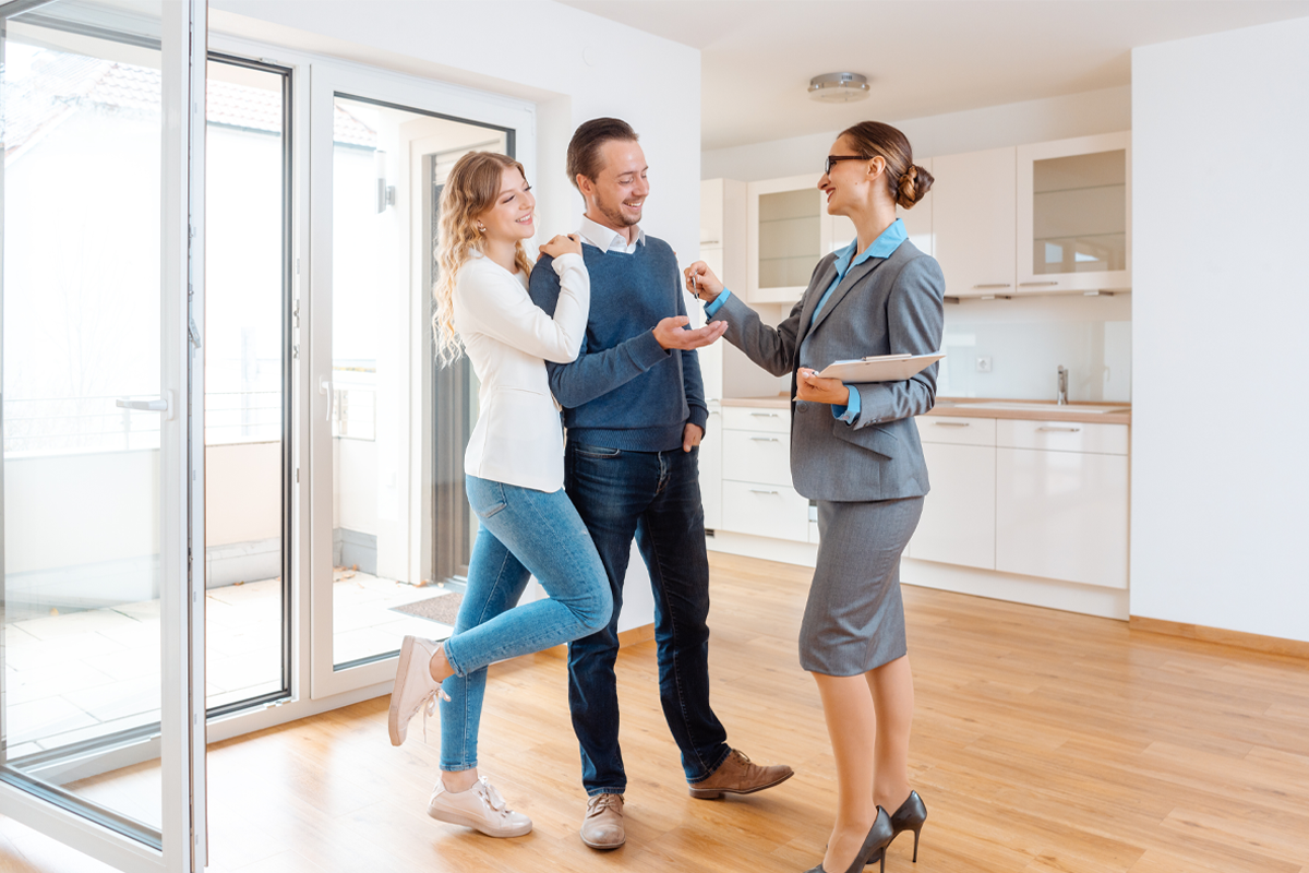 A smiling landlord shaking hands with a professional property manager